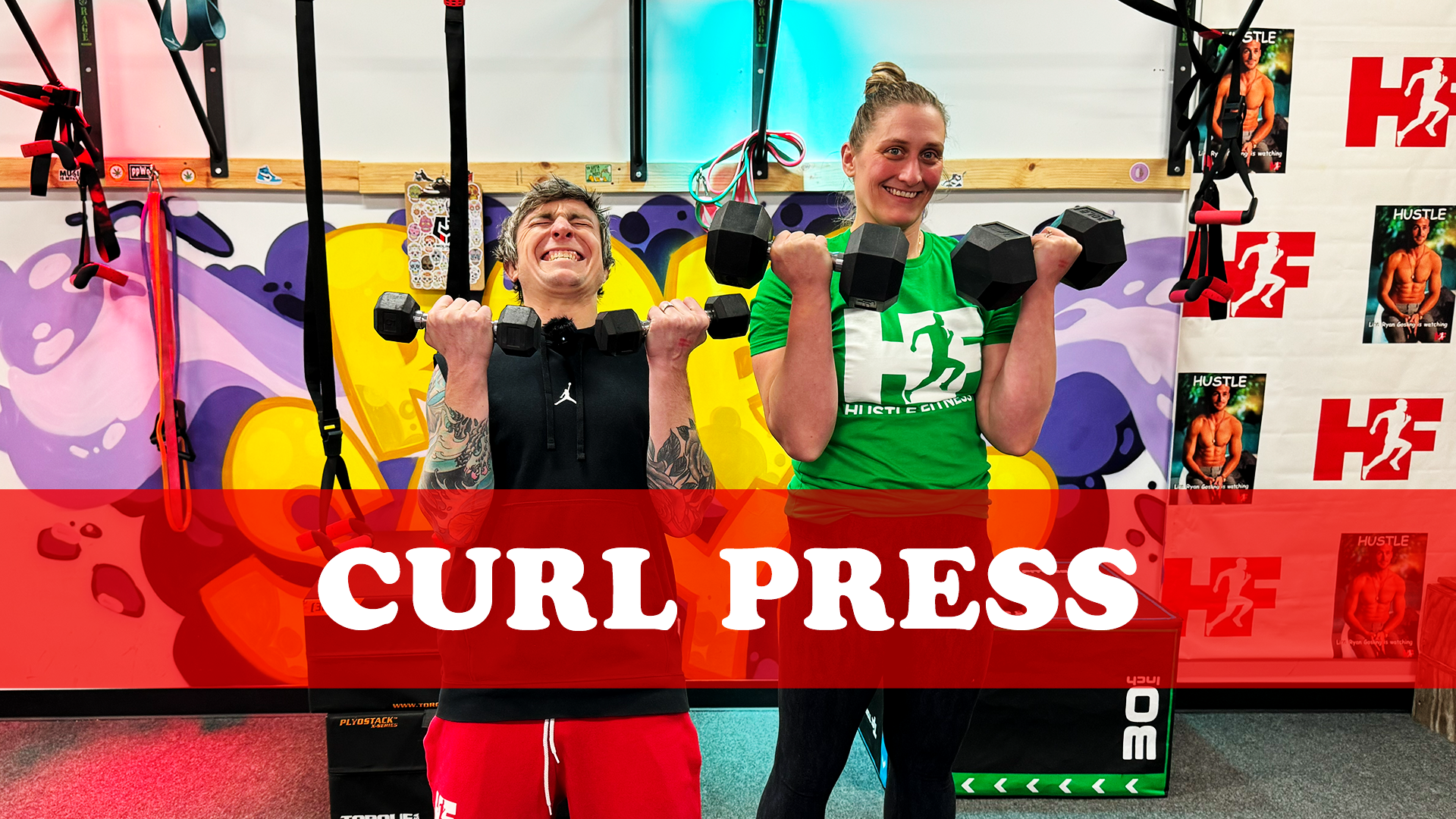 Two people performing curl press exercise.